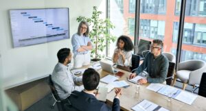 People sat around discussing documents in an office meeting room