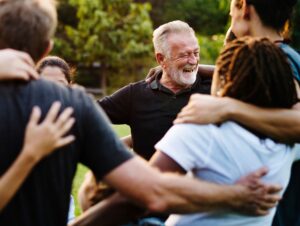 group of people huddle and smiling together