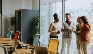 Photo of four people in an office meeting room