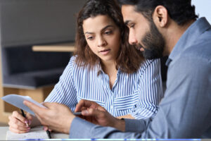 Two people discussing documents together