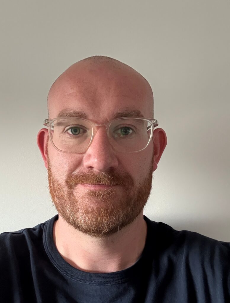 Picture of Will Clothier looking at the camera with a light background