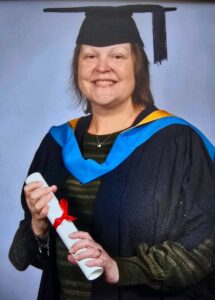 A photo of Maria Smith in her graduation clothing smiling